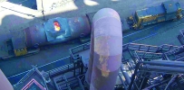 An aerial view of a torpedo rail car showing the size of the aperture the molten iron has to pass through